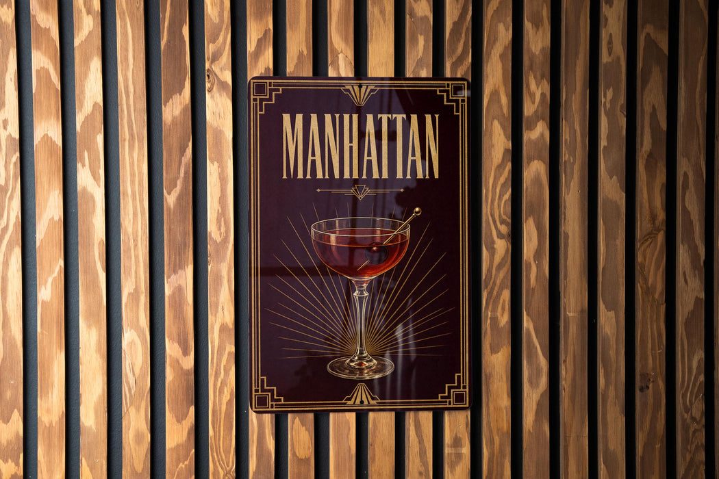 A poster or sign for "Manhattan" cocktail, featuring a glass of Manhattan cocktail with a straw.