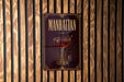 A poster or sign for "Manhattan" cocktail, featuring a glass of Manhattan cocktail with a straw.