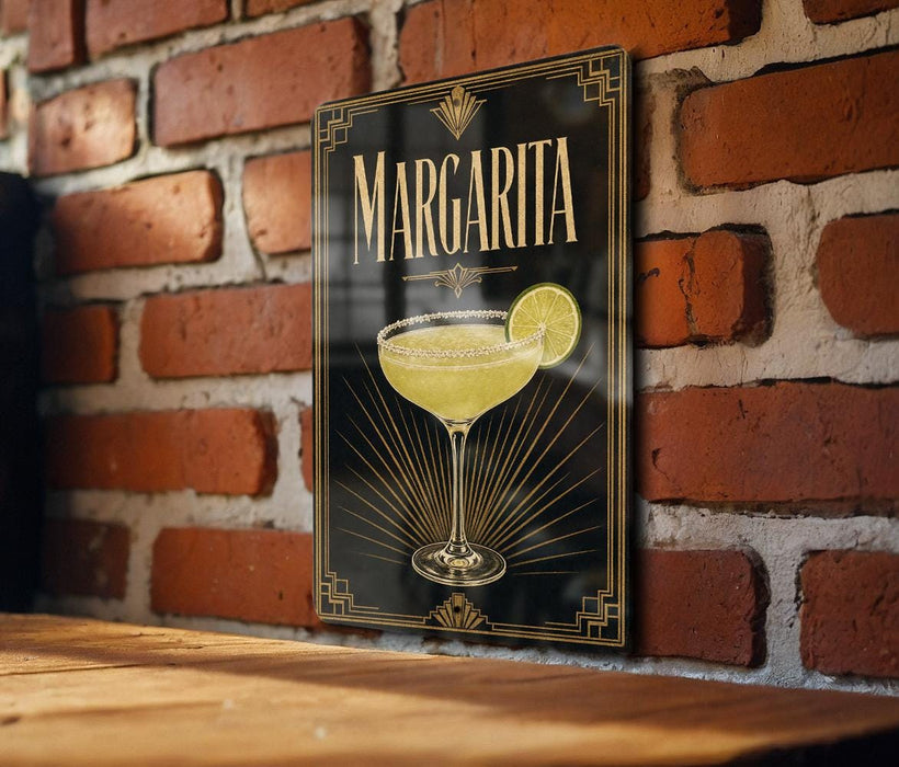 A framed poster of a margarita glass is displayed on a brick wall.