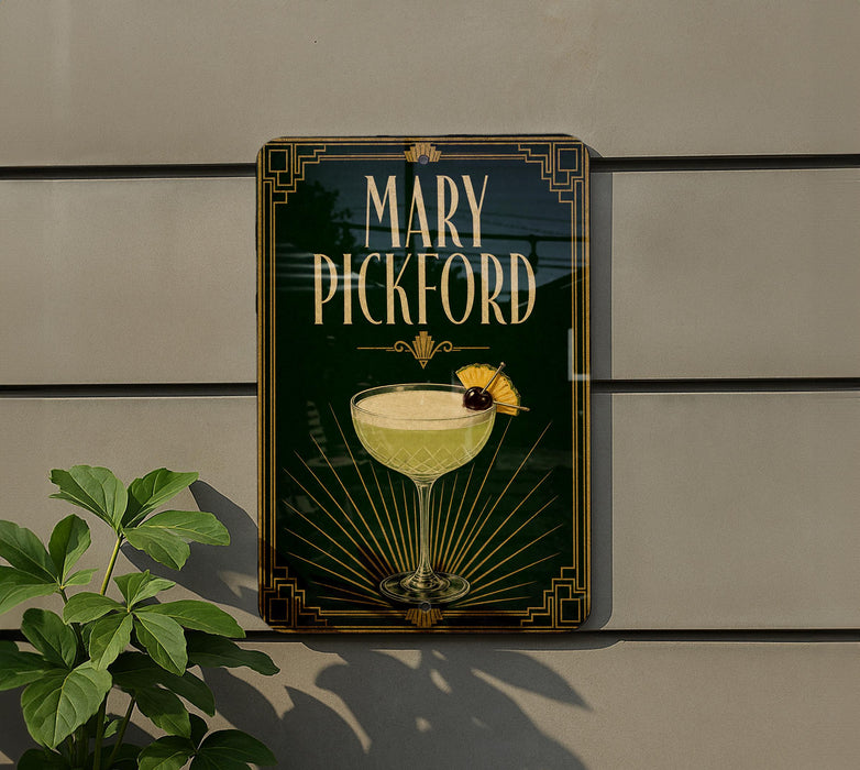 A decorative sign for "Mary Pickford" cocktail, featuring a glass illustration and a decorative border.