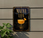 a decorative sign with the text "MAUNA LOA" and an illustration of a cocktail glass with a pineapple garnish.
