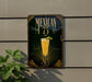 A decorative sign with the text "MEXICAN 1775" and an illustration of a glass of Mexican drink, possibly a margarita or a similar cocktail, against a dark background with a decorative border.
