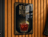 A sign for "Mexican Bulldog" cocktail, featuring an illustration of a glass filled with a red drink and a lime wedge.