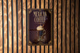 A sign for "Mexican Coffee" is displayed on a wooden wall.