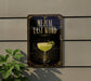 A sign with the text "MEZCAL LAST WORD" and an illustration of a cocktail glass with a lime on a wall.