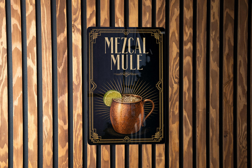 A sign for a Mezcal Mule, featuring an illustration of a copper mug with a lime slice, is displayed on a wooden wall.
