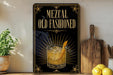 A framed advertisement for Mezcal Old Fashioned, featuring an illustration of a glass of Mezcal with a lemon twist.