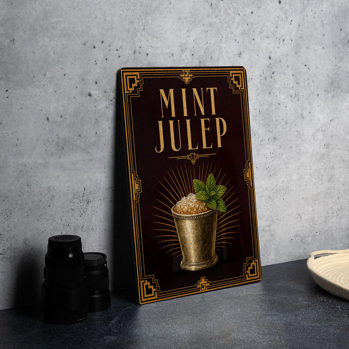 A framed illustration of a mint julep cocktail on a dark background, with a decorative border and the text "MINT JULEP" prominently displayed.