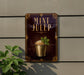 a sign for a mint julep cocktail, with a decorative border and a picture of a mint julep in a glass.