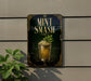 a sign that reads "MINT SMASH" with an illustration of a glass containing a mint leaf and a small amount of mint on a wall.