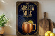 a poster advertising Moscow Mule, a Moscow-style alcoholic beverage, with a copper mug and lemon slice on the poster.