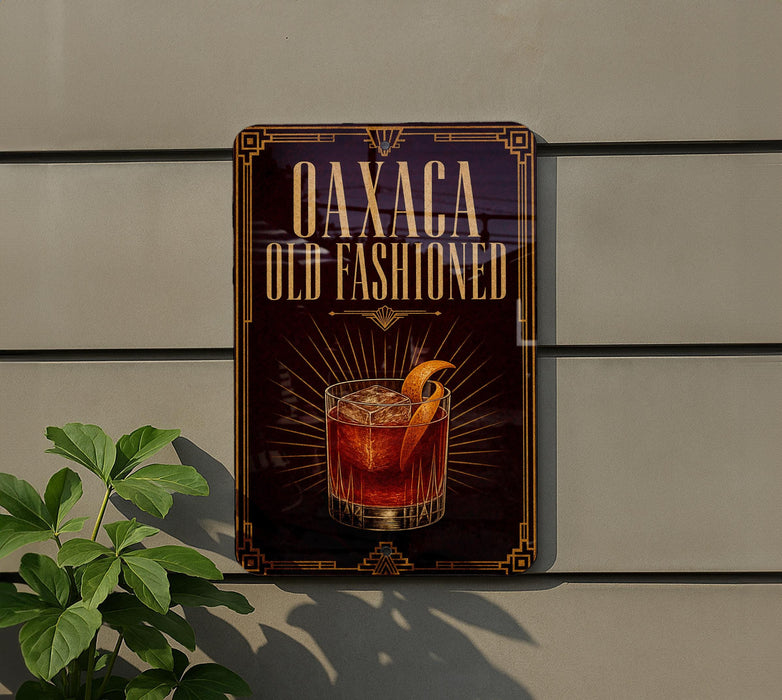 a sign for "Oaxaca Old Fashioned" cocktail, which is displayed on a wall.