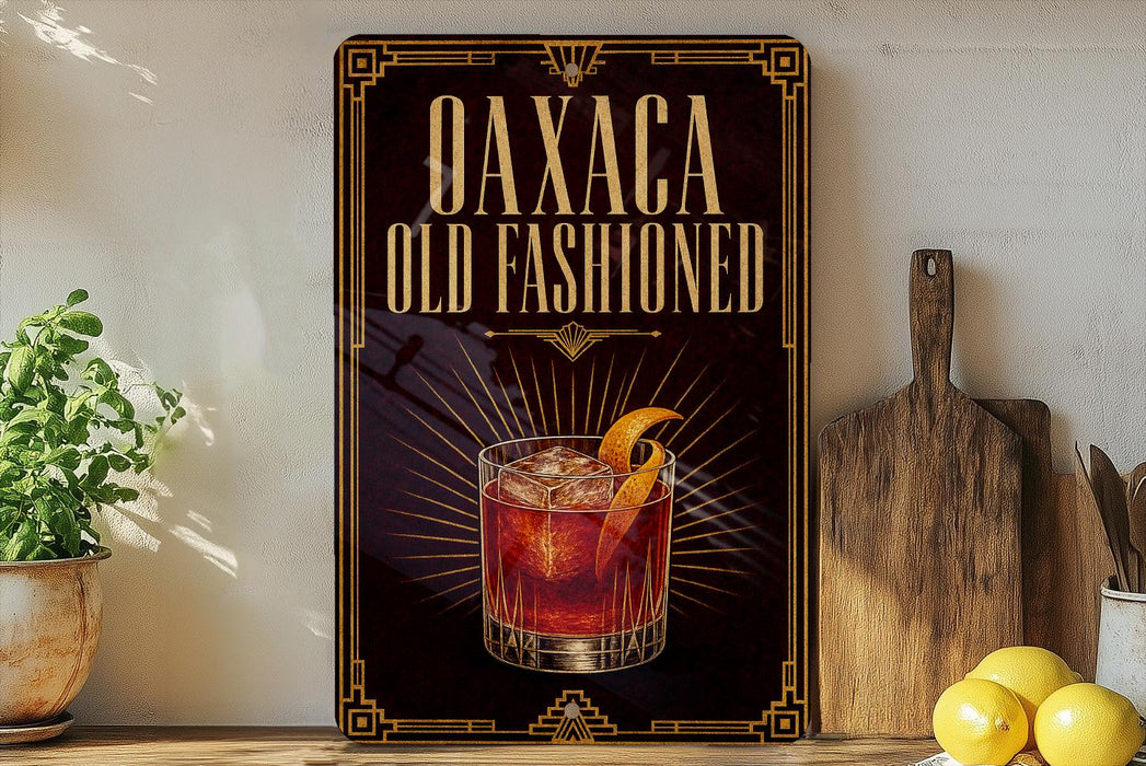 a decorative sign with the text "Oaxaca Old Fashioned" and an illustration of a cocktail glass with an orange peel.