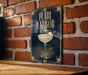 A sign for "Pearl Harbor" is displayed on a brick wall, featuring an illustration of a cocktail glass with a cherry on top.