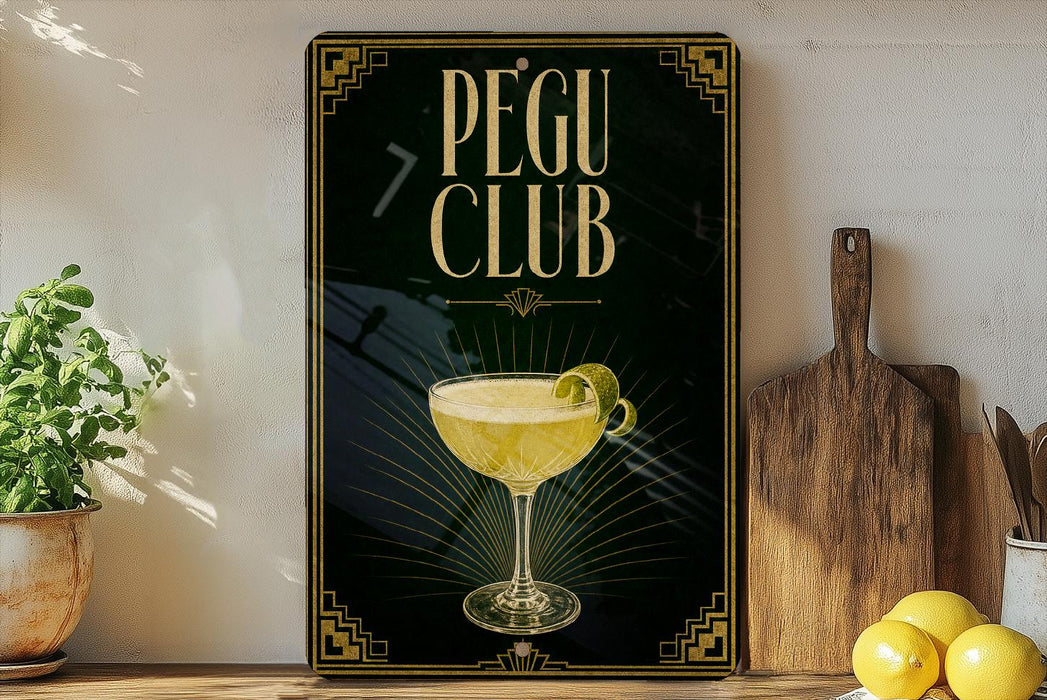 A framed poster with the text "PEGU CLUB" and an illustration of a cocktail glass on a wooden shelf.