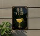 A sign for the "Pegu Club" featuring a glass of yellow liquid, likely a cocktail, with a decorative design.