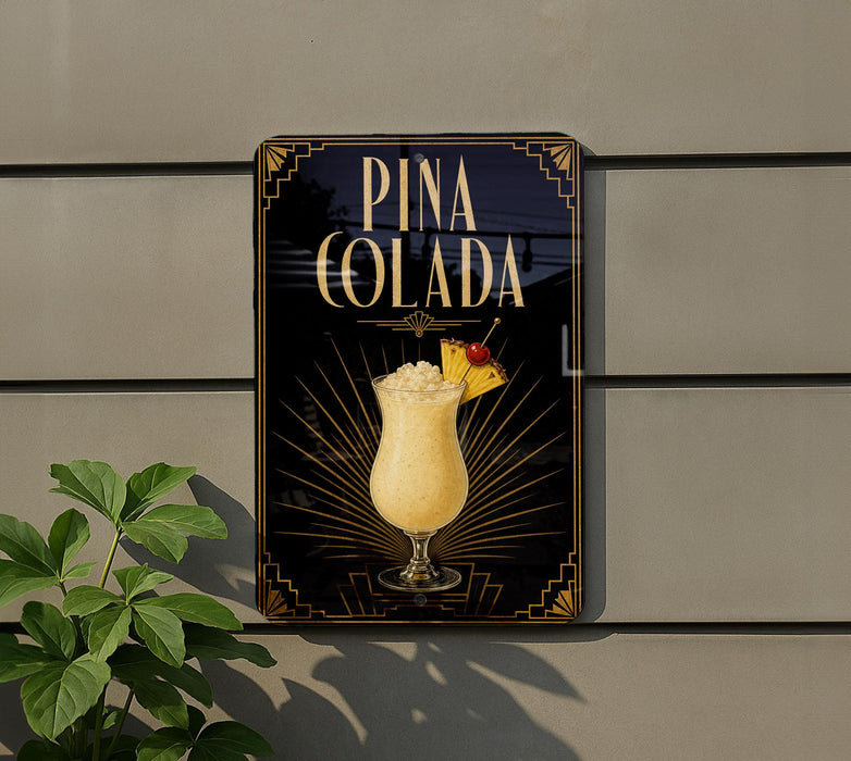 A sign for Pina Colada, featuring a glass of the tropical drink with a pineapple garnish, is displayed on a wall.