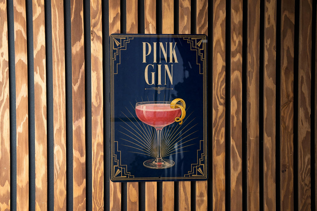 A sign for a pink gin cocktail is displayed on a wooden wall.