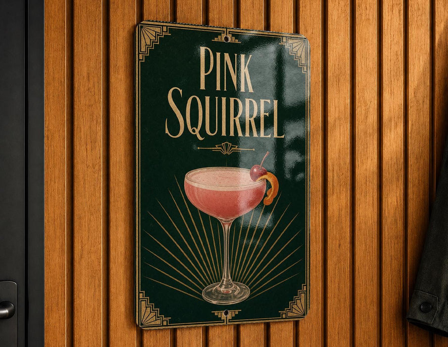 A sign for a pink squirrel cocktail is displayed on a wooden wall.