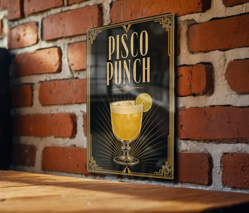 A sign for "Pisco Punch" is displayed on a brick wall, featuring an illustration of a glass of pisco along with a lemon slice.