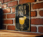 A sign for "Pisco Punch" is displayed on a brick wall, featuring an illustration of a glass of pisco along with a lemon slice.