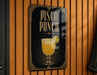 A sign for "Pisco Punch" is displayed on a wooden wall.