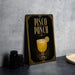 A framed poster or sign advertising a "Pisco Punch" drink, featuring an illustration of a glass filled with a yellow-colored beverage and a lemon slice.