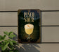 A sign for a drink called "Pisco Sour" is displayed on a wall, featuring a glass of pisco sour with a frothy white head and a slice of lemon.