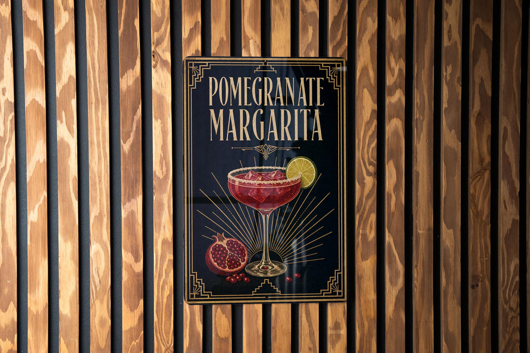 A poster for a pomegranate margarita is displayed on a wooden wall.