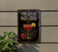 A decorative sign for a pomegranate margarita cocktail, featuring a glass of the drink and garnished with pomegranate seeds and a lemon slice.