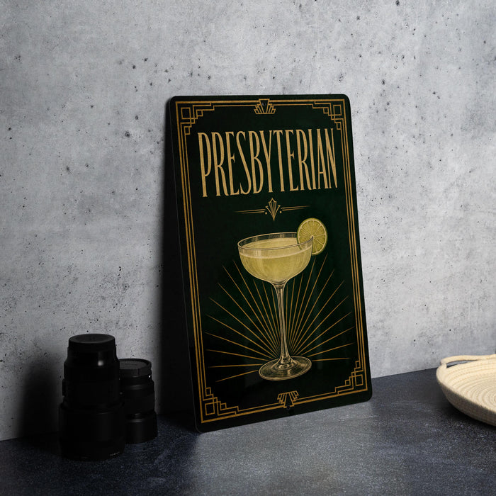 A framed poster or sign with the text "PRESBYTERIAN" and an illustration of a cocktail glass with a lemon slice.