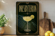 A decorative sign for "Presbyterian" cocktail, featuring a glass of yellow liquid with a lemon slice, is displayed on a shelf next to a wooden cutting board and a potted plant.
