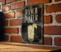 A sign for Ranch Water is displayed on a brick wall, featuring an illustration of a glass of water with a lime slice.