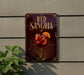 a sign for "Red Sangria" hanging on a wall, with a glass of red wine and orange slices displayed on the sign.