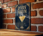 A poster or sign with the text "REVERSE MARTINI" and an illustration of a martini glass with a lemon twist.