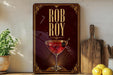 a decorative sign with the name "Rob Roy" on it, along with a martini glass and a lemon.