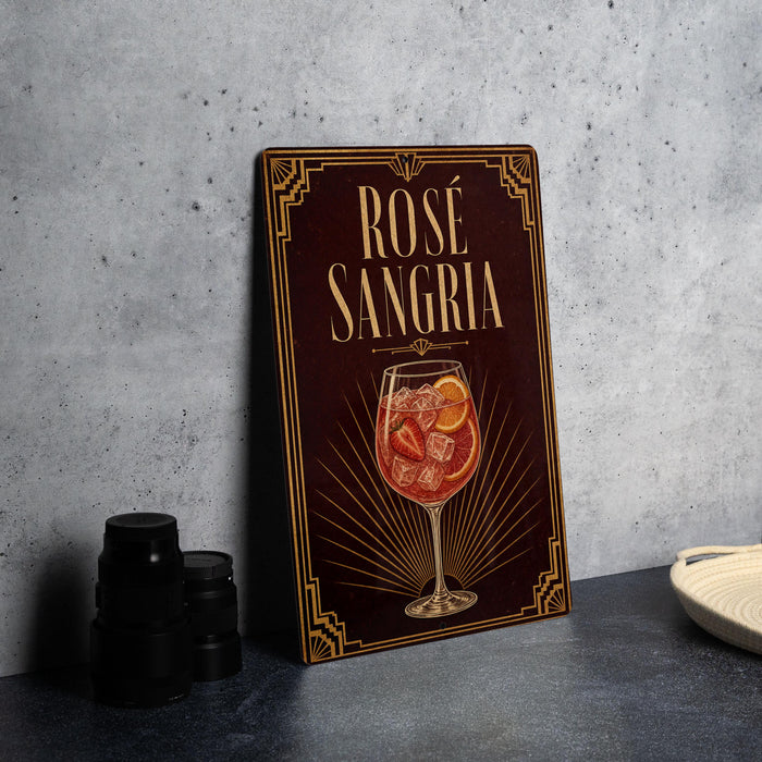 A wooden sign with the text "ROSE SANGRIA" and an illustration of a glass of rose-colored liquid, possibly a cocktail or wine, with garnishes.