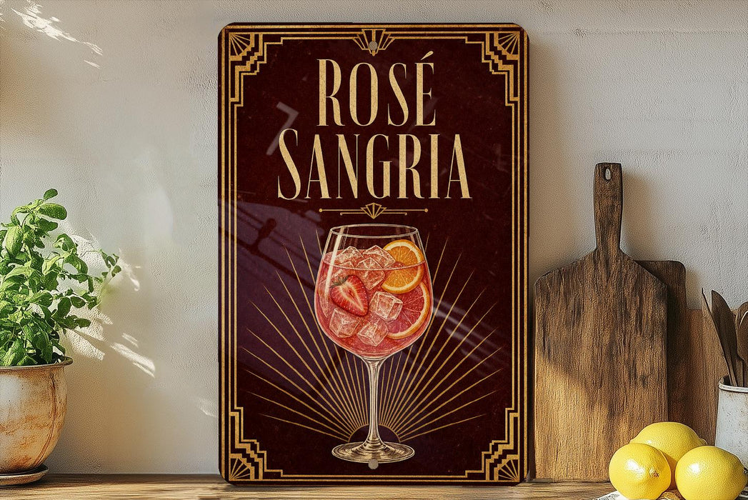 a decorative sign for "Rose Sangria" with a glass illustration of a rose-infused drink, placed on a wooden surface next to a potted plant and a cutting board.