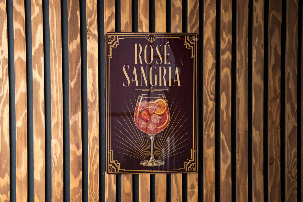 A sign for "Rose Sangria" is displayed on a wooden wall.