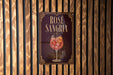 A sign for "Rose Sangria" is displayed on a wooden wall.
