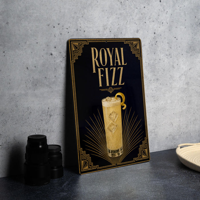 A framed poster advertising "Royal Fizz" on a wall, featuring an illustration of a cocktail glass with ice cubes.
