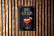 A poster advertising "Royal Hawaiian" cocktail, featuring a glass of the drink with a pineapple garnish.
