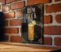 a poster advertising a rum and coke drink called "RUM BUCK" with a glass illustration of the drink and a lime slice.