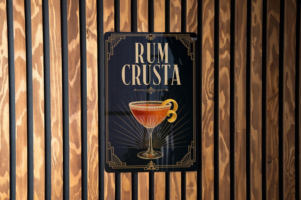 a sign with the text "RUM CRUSTA" and an illustration of a cocktail glass.