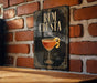 A sign with the text "RUM CRUSTA" and an illustration of a cocktail glass with a lemon peel.