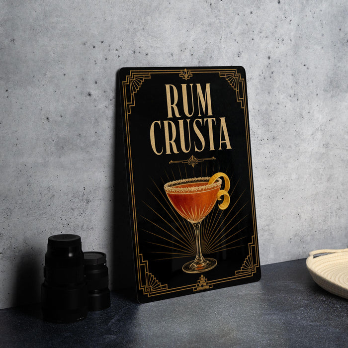 a decorative sign with the text "RUM CRUSTA" and an illustration of a cocktail glass.
