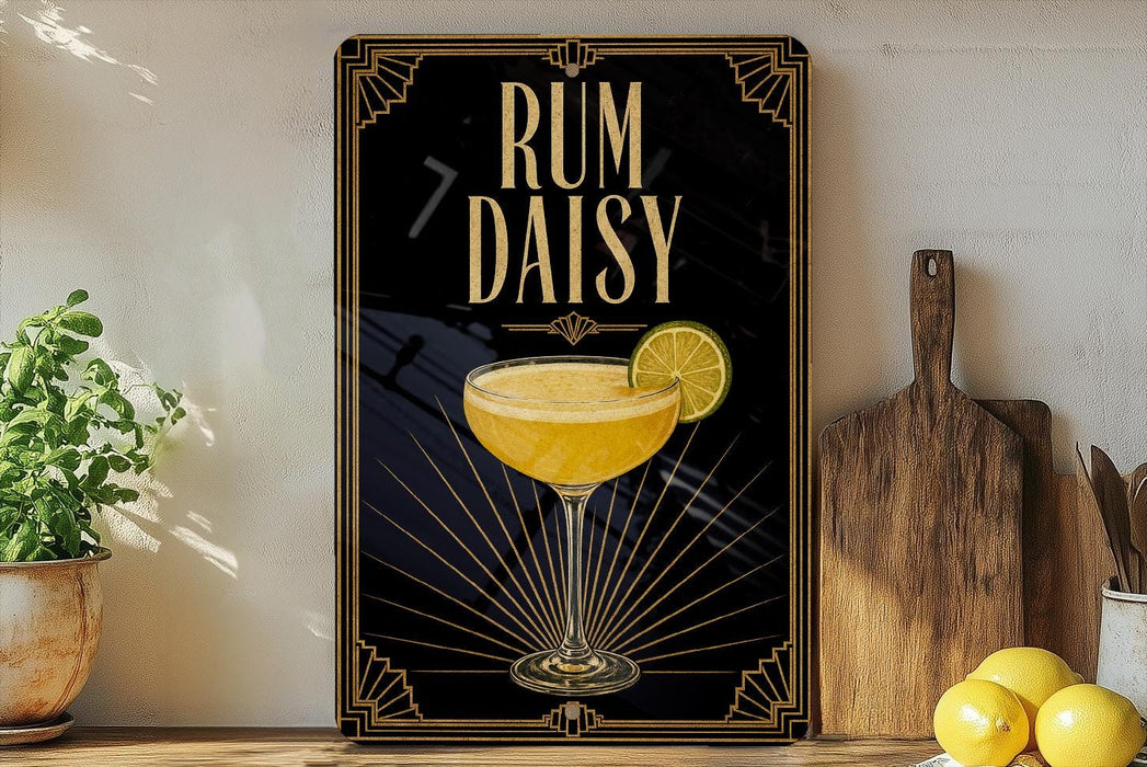 a framed poster with an illustration of a cocktail glass and a lemon slice, along with the text "RUM DAISY" on a black background with gold accents.
