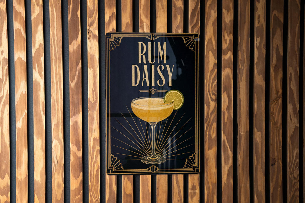 A poster with the text "RUM DAISY" and an illustration of a cocktail glass with a lemon slice.