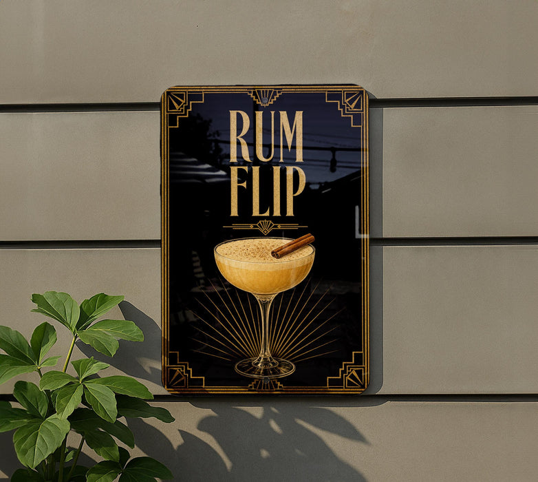 a sign with the text "RUM FLIP" and an illustration of a cocktail glass with a cinnamon stick.