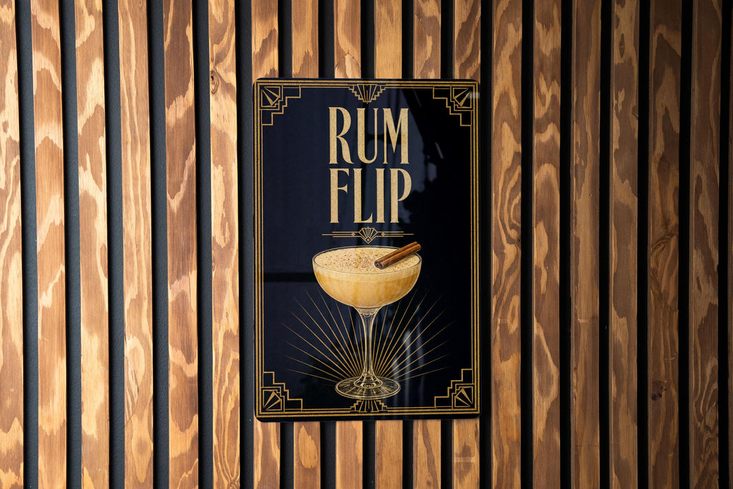 A poster with the text "RUM FLIP" and an illustration of a cocktail glass with a cinnamon stick.